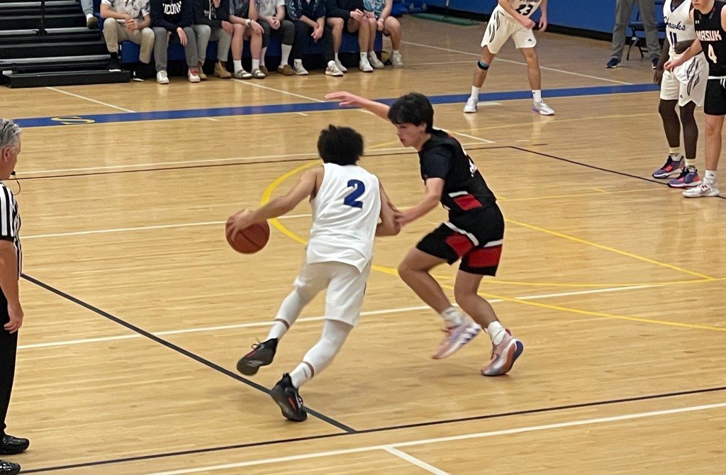Masuk sophomore Stephen Sentementes (right) defending junior Newtown player Makai Coleman (left).